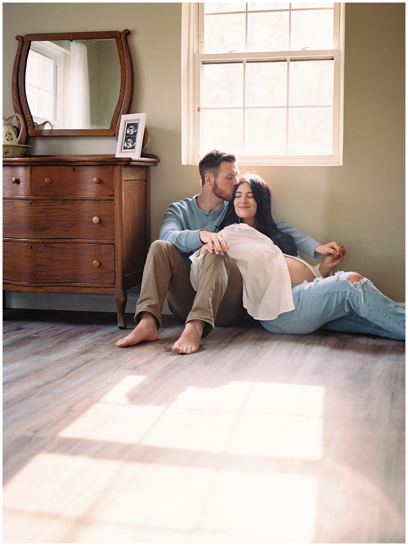 Dad shares a forehead kiss with mom during timeless and magical Knoxville maternity session.