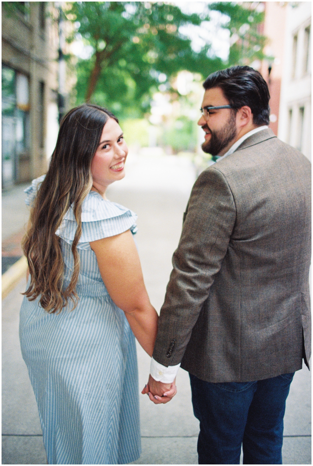 Ashley smiles over her shoulder while Jackson looks at her for anniversary session