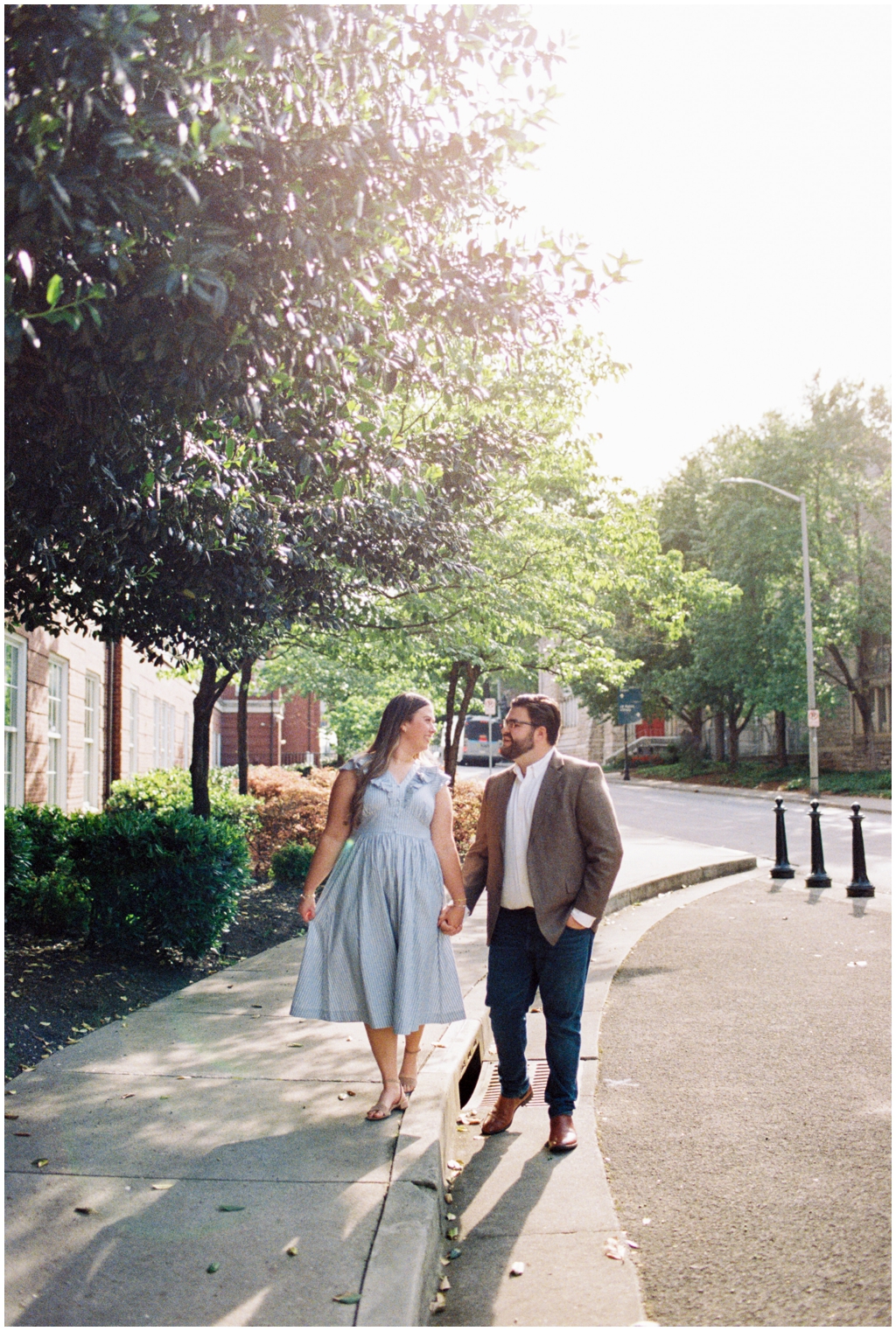 Ashley holds hands with husband Jackson in downtown knoxville for summer anniversary session