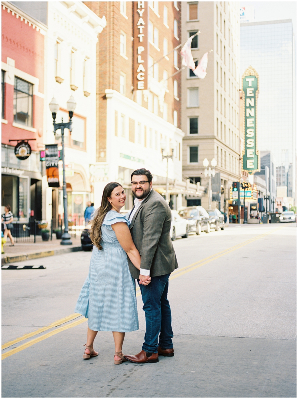 Husband and wife pose on Gay Street in downtown knoxville during anniversary session