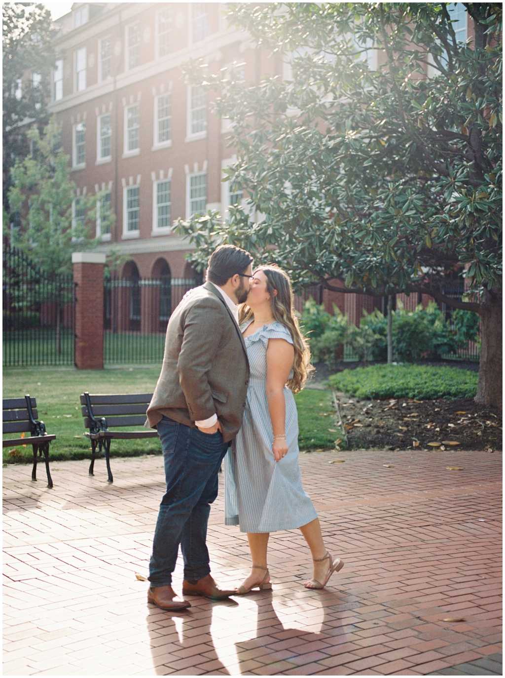 Husband and wife share a sweet kiss during their anniversary session in downtown knoxville