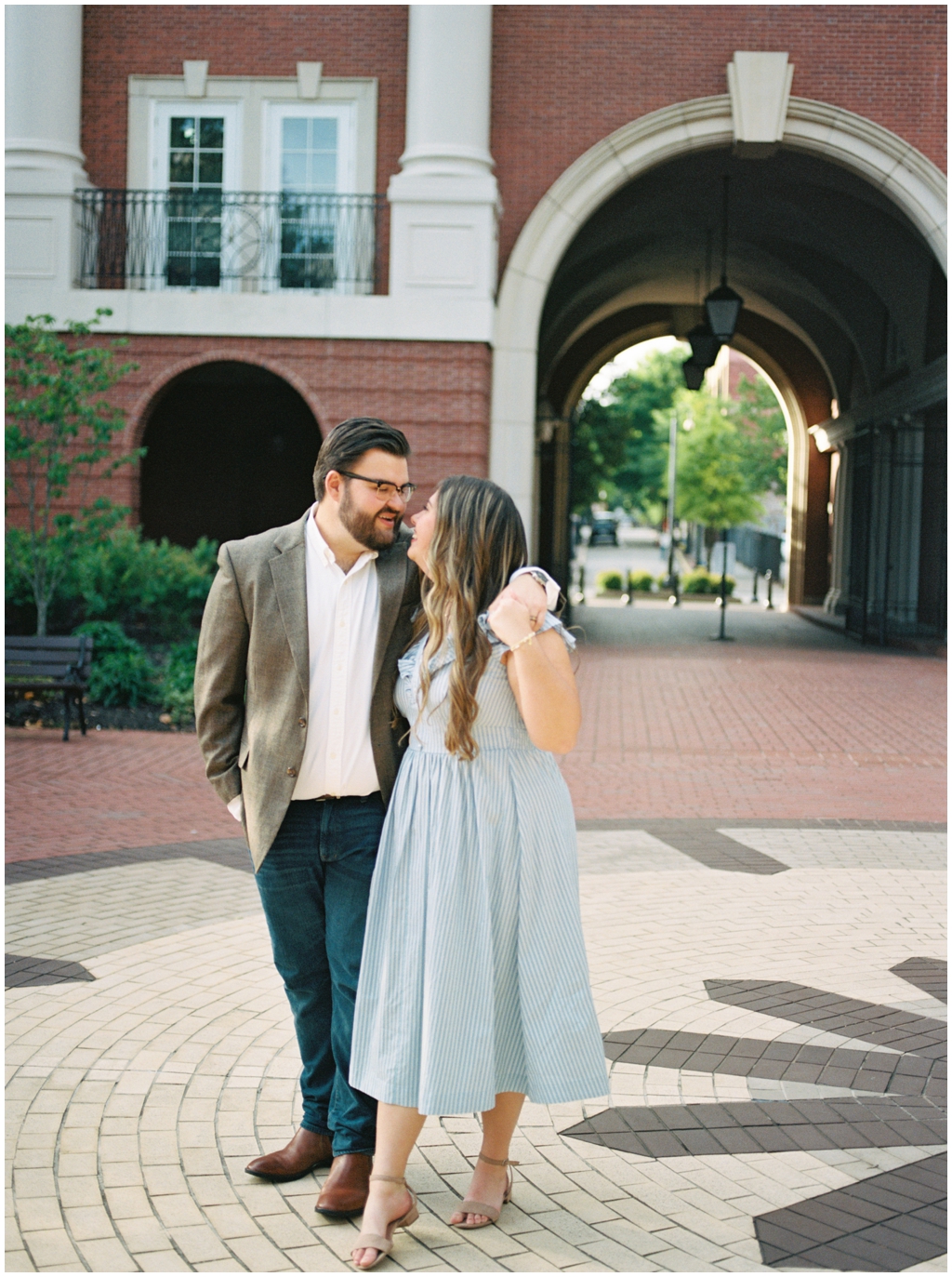 Husband and wife stroll through downtown brick streets together for knoxville anniversary session