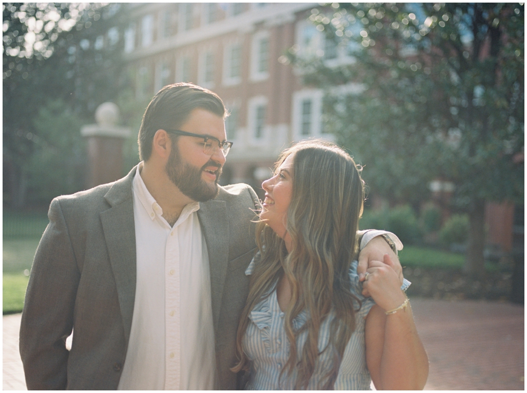 Husband and wife pose in urban downtown knoxville during dreamy summer anniversary session.