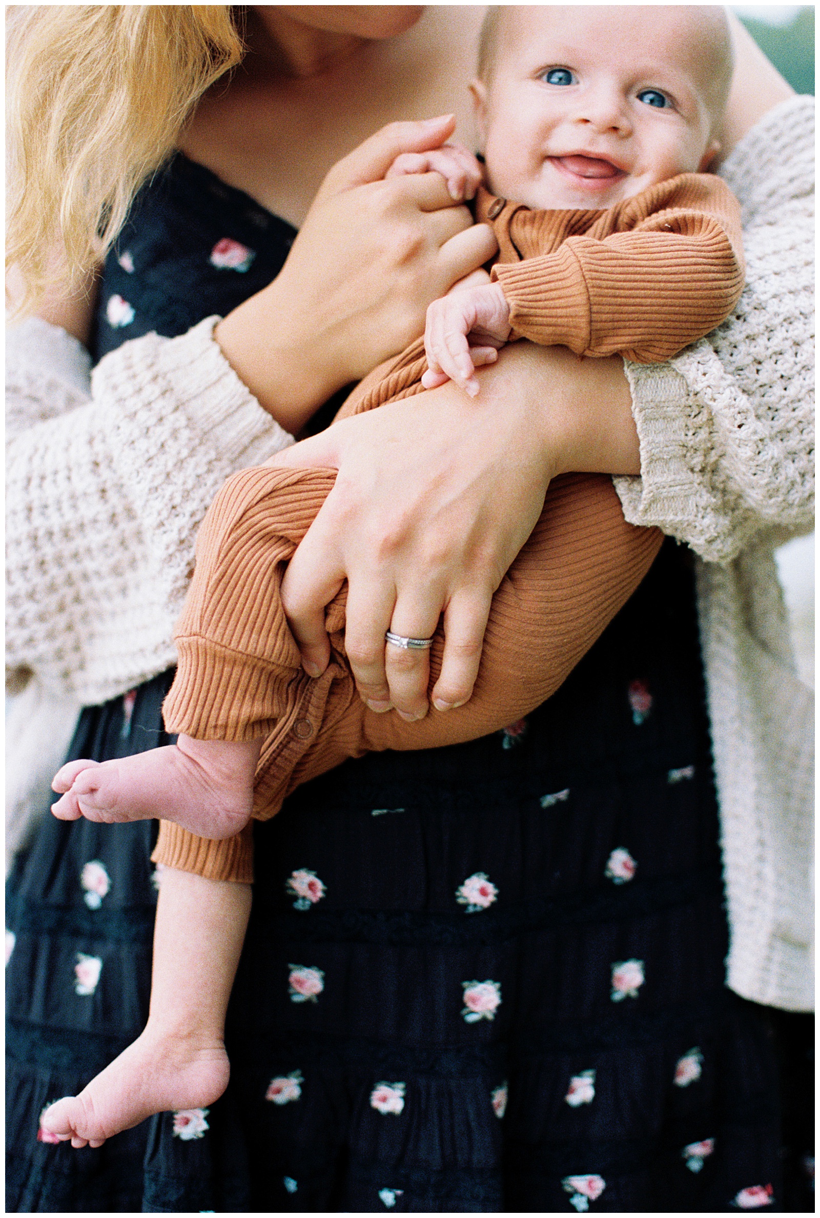 Newborn laughs for Lake Michigan relaxed family session