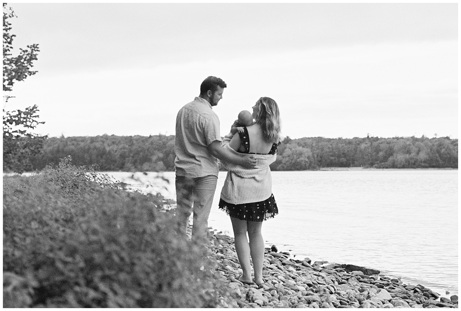 Black and white image of adorable family on the shores of Lake Michigan