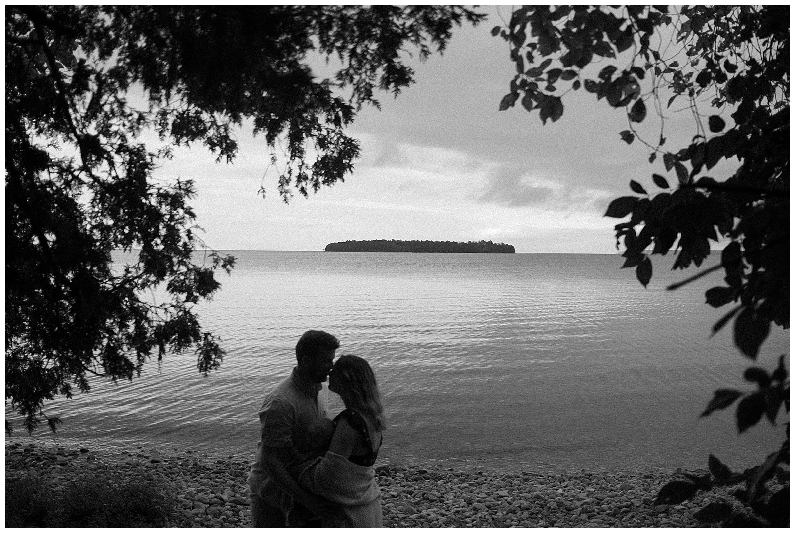 Black and white silhouette of mom and dad during lake michigan family session