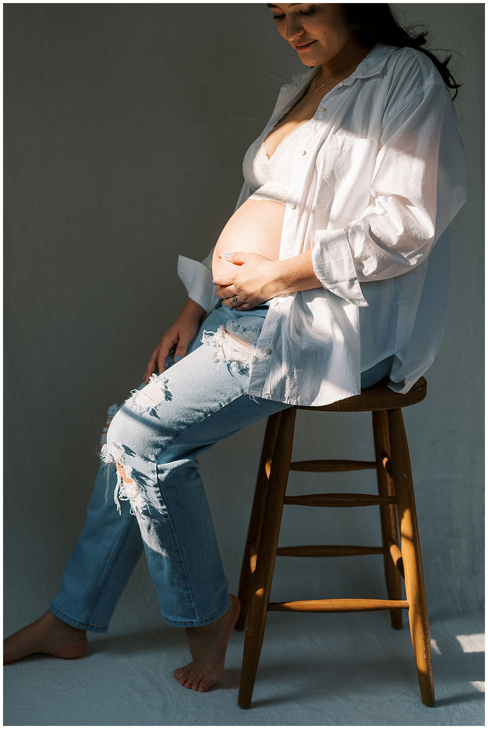 Expecting mother poses for portrait for maternity session in-home in Knoxville