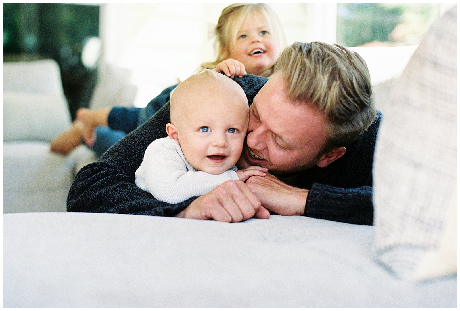 Dad cuddles with kids during quaint and intimate Knoxville in-home lifestyle session