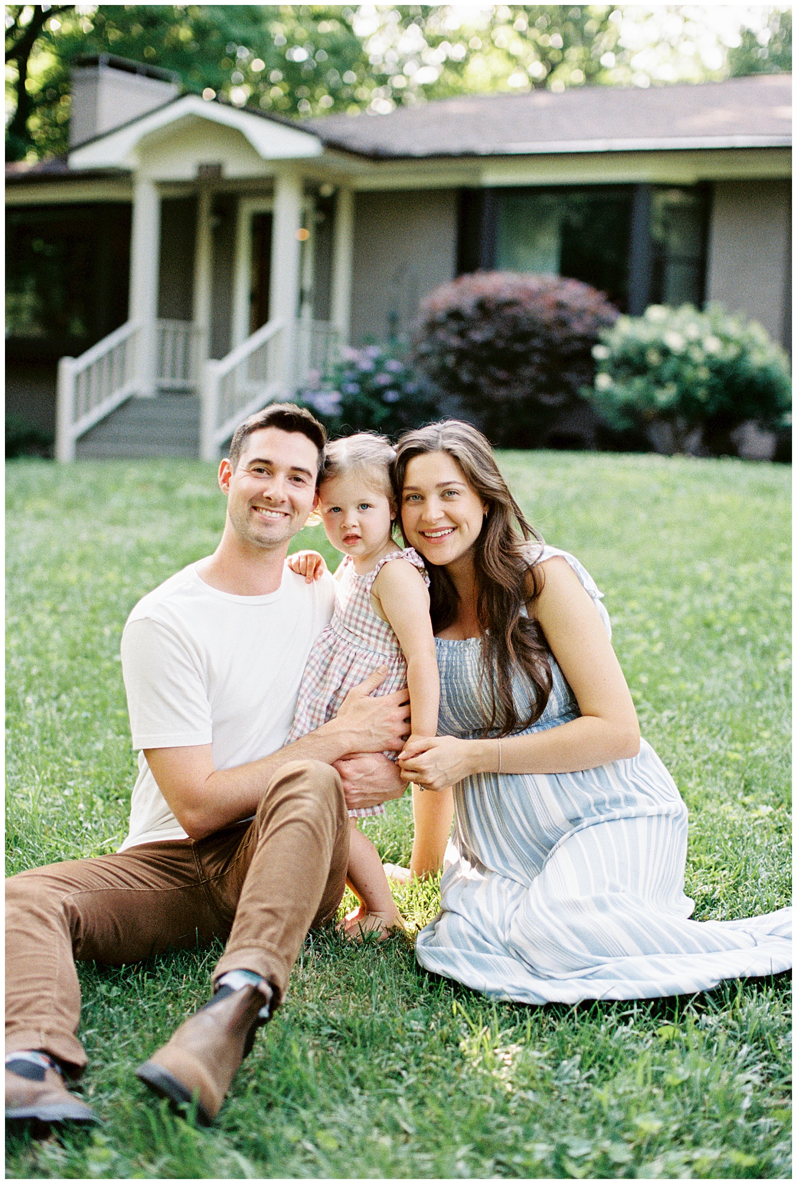 Family of three pose during knoxville maternity in-home session