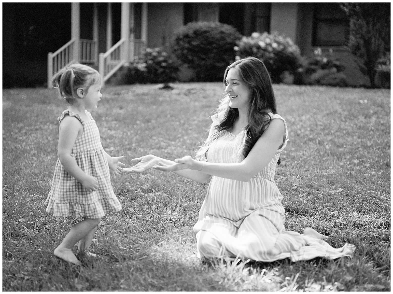 Black and white image of mom and daughter playing during in-home knoxville maternity session