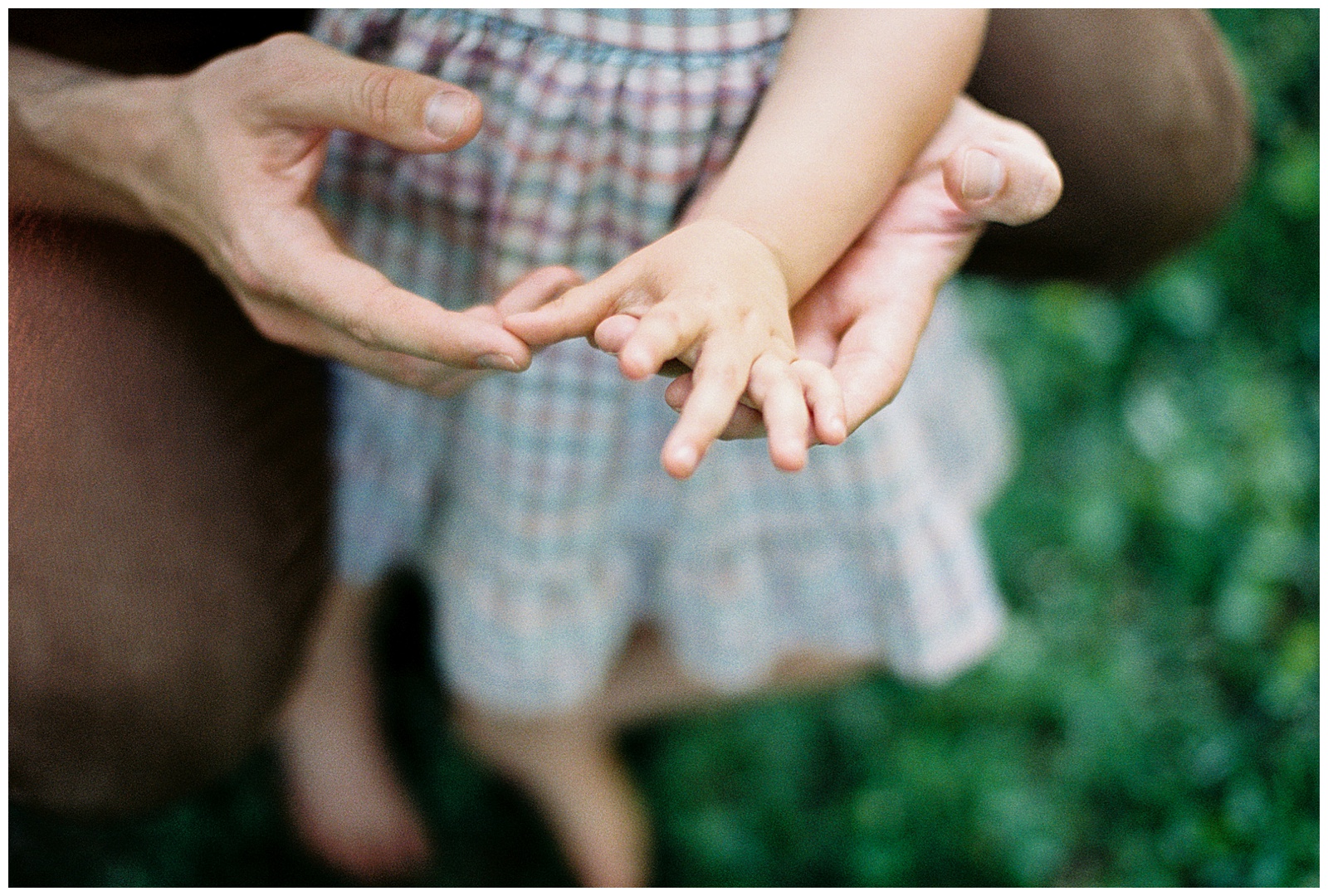 Detailed image of parent and child's hands during maternity session