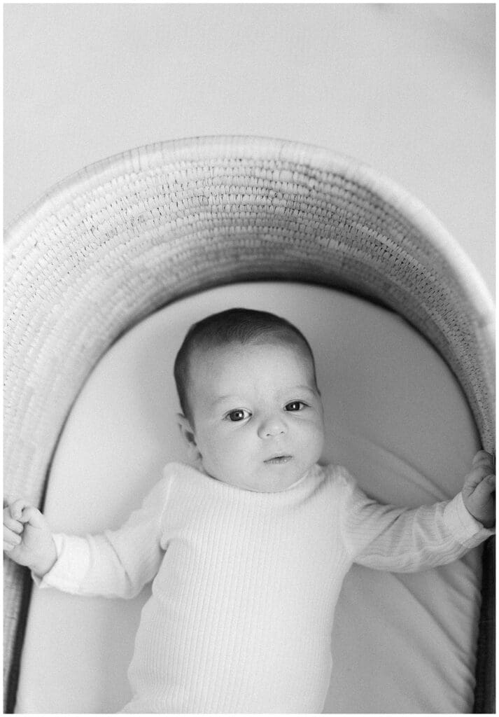 Black and white portrait of newborn baby in their bassinet in Knoxville, TN by Holly Michon Photography