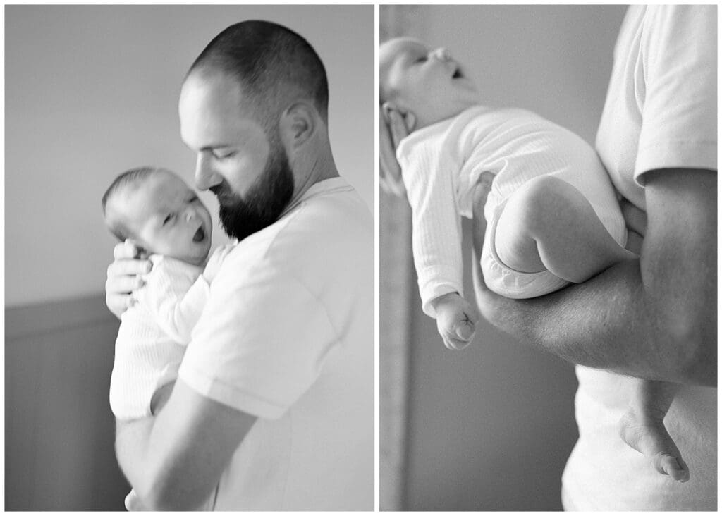 Black and white portrait and detail shot of dad holding his newborn baby in his arms, baby yawning. By Holly Michon Photography