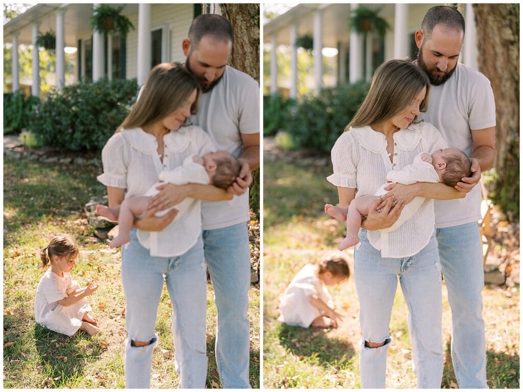 Newborn photography at home in Knoxville, TN with mom and dad cradling baby in their arms.